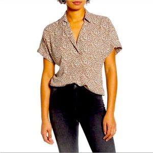 Cute, versatile, and comfy leopard print top with button detail on back.